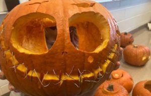Jack-o-lantern with safety pins in mouth