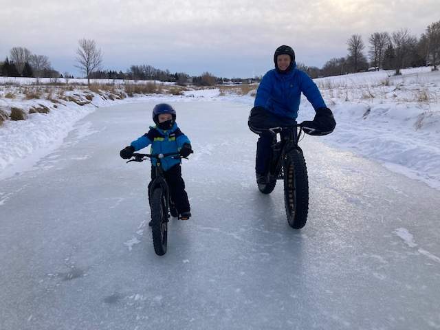 dad and son biking in winter