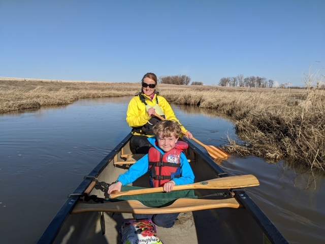 Family microadventuring in a canoe on a creek