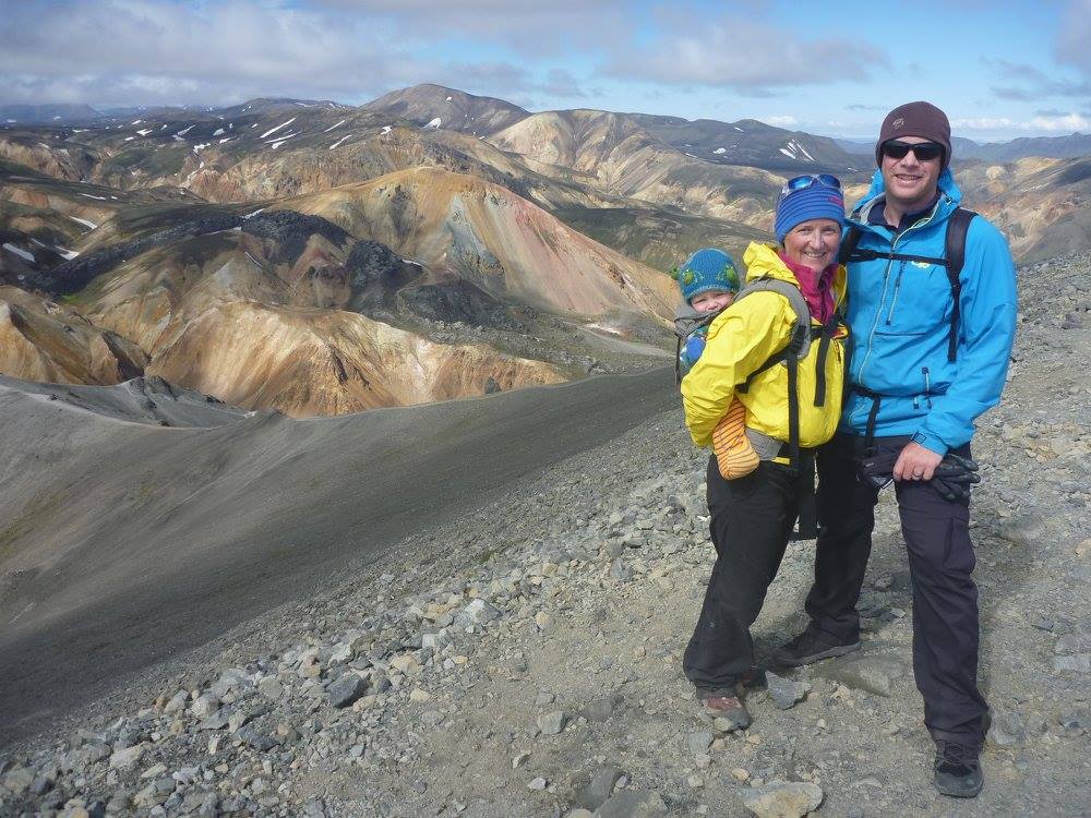 Couple with baby on mountain summit in Iceland